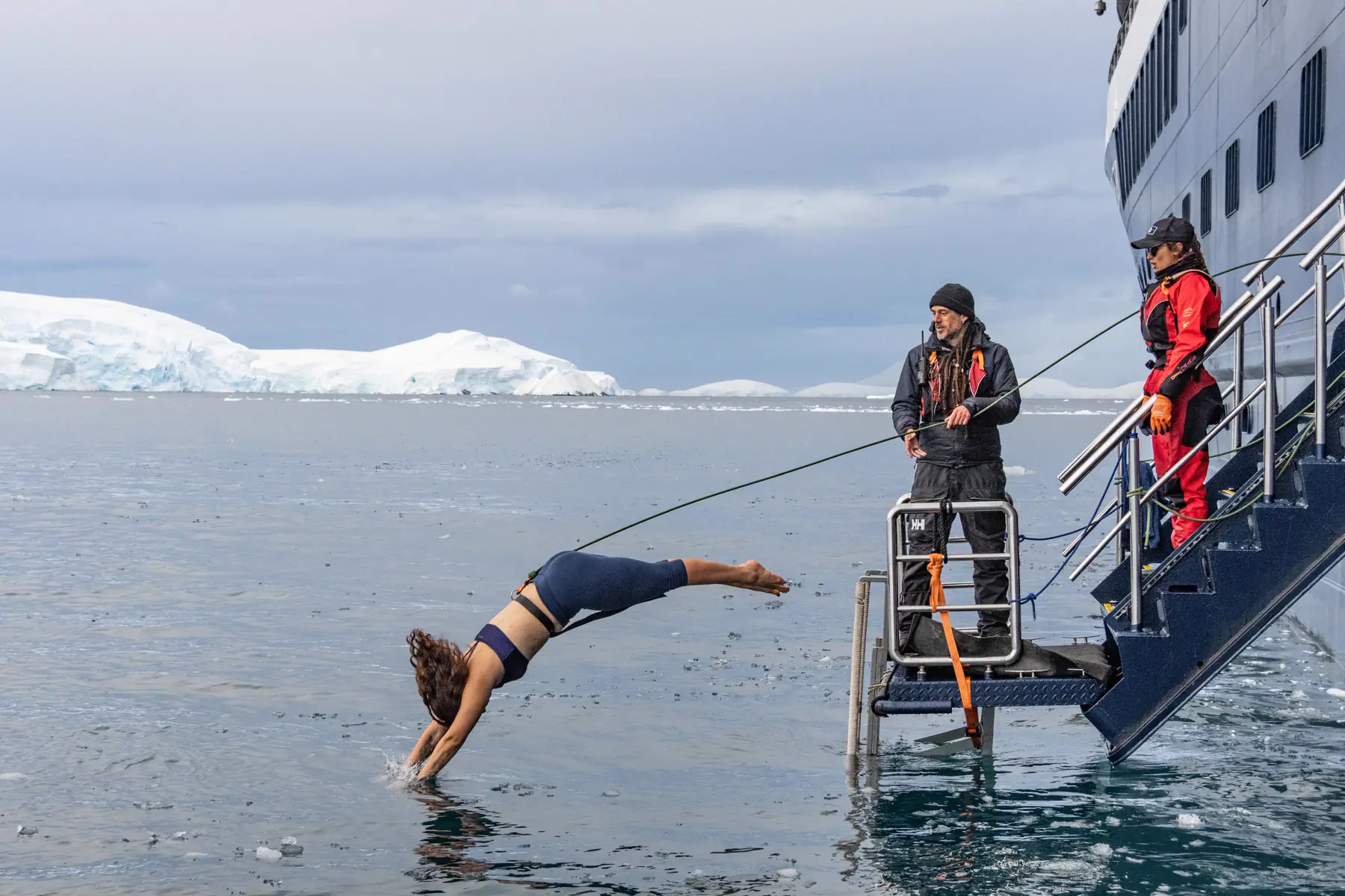 A traveller diving from a ship's gangway into icy water