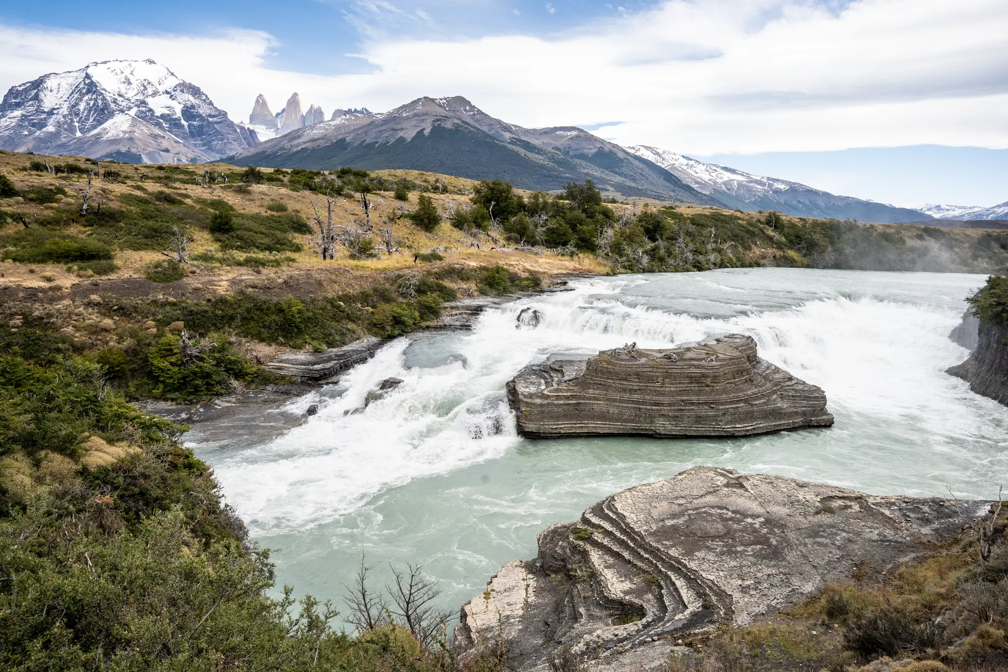 Paine waterfall with the granite towers of Torres del Paine behind