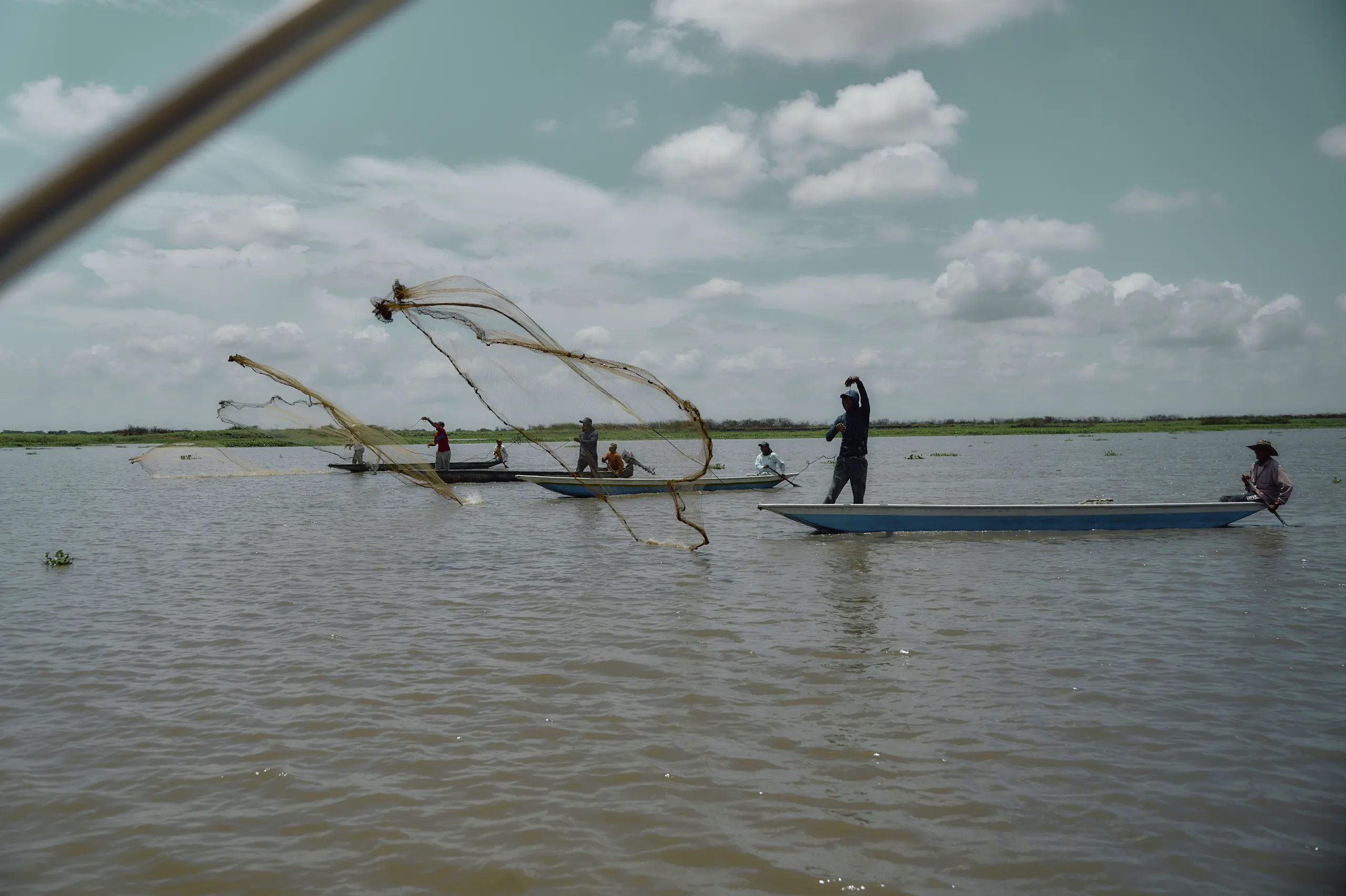 Fishermen casting traditional nets on the Magdalena River