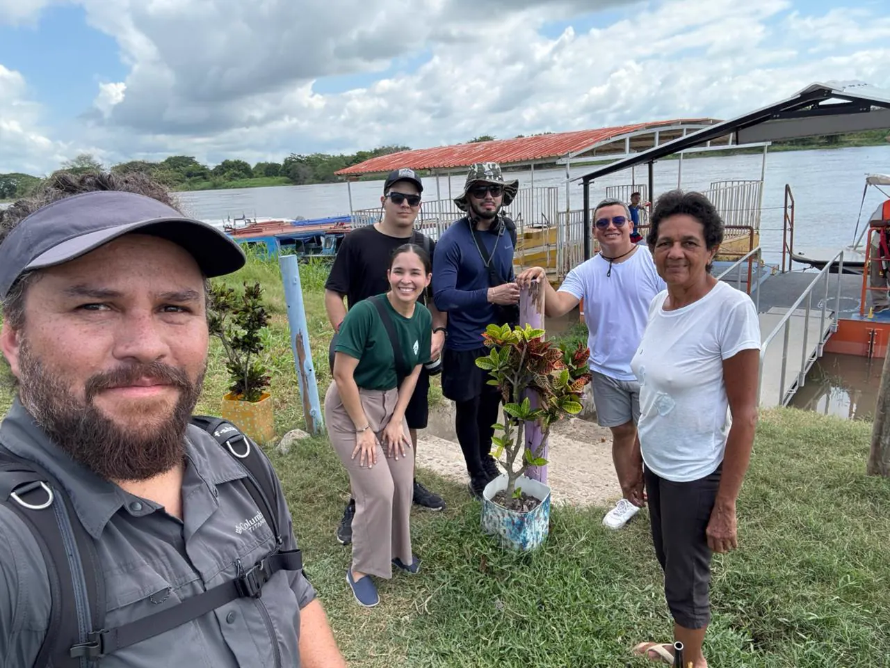 The Foundation team with a woman from the community on the riverbank