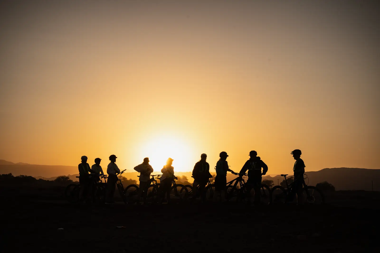 Riders silhouetted against the sunset in the Atacama Desert